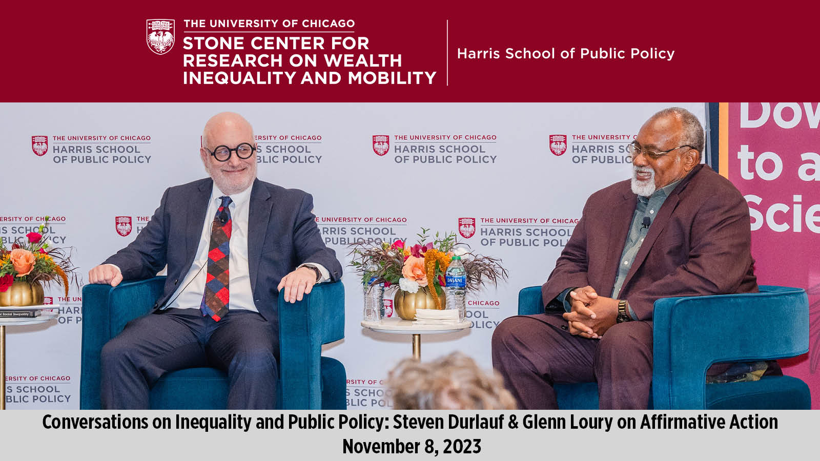 Steven Durlauf (left) and Glenn Loury (right) seated on a stage. 