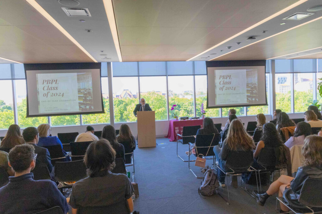 Director Steven Durlauf presents thesis awards in front of students' friends and family at the Harris End of Year Celebration on May 15, 2024.