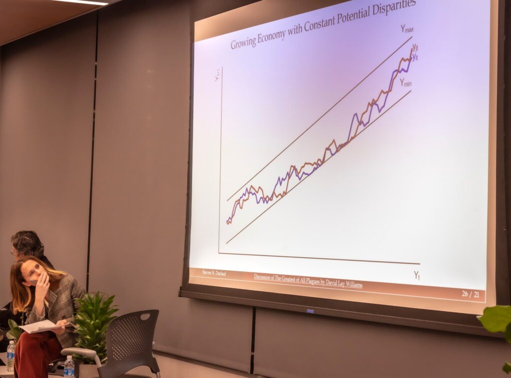 A panelist studies the graph during a moment of reflection.