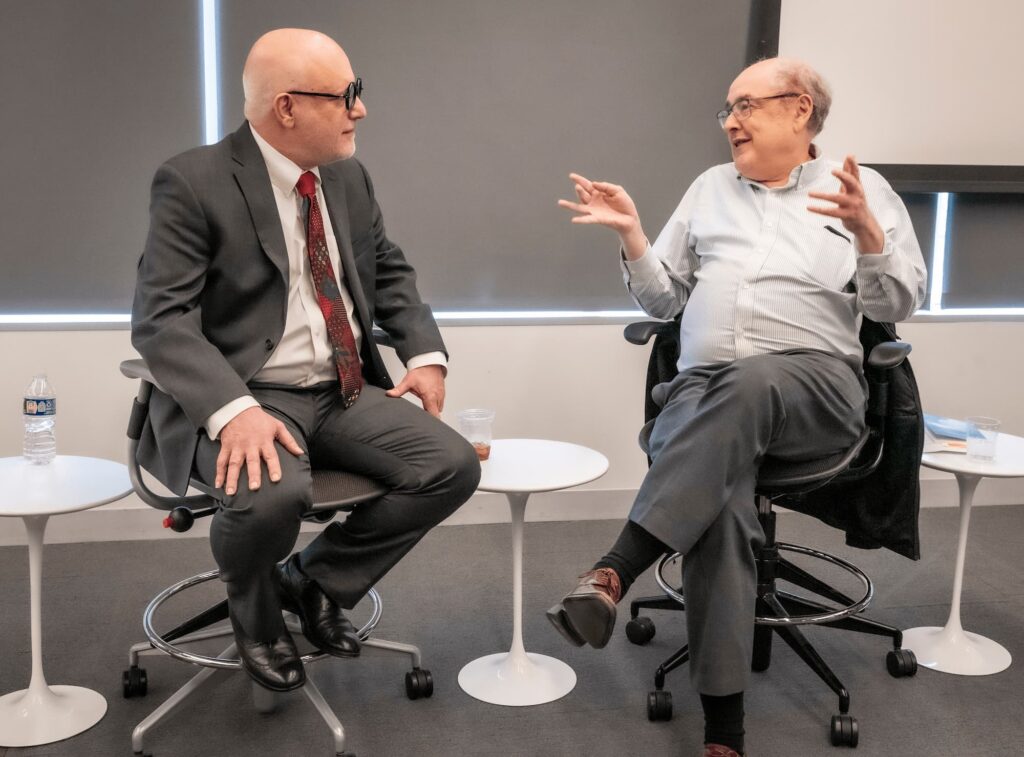 A candid moment of scholarly discussion.