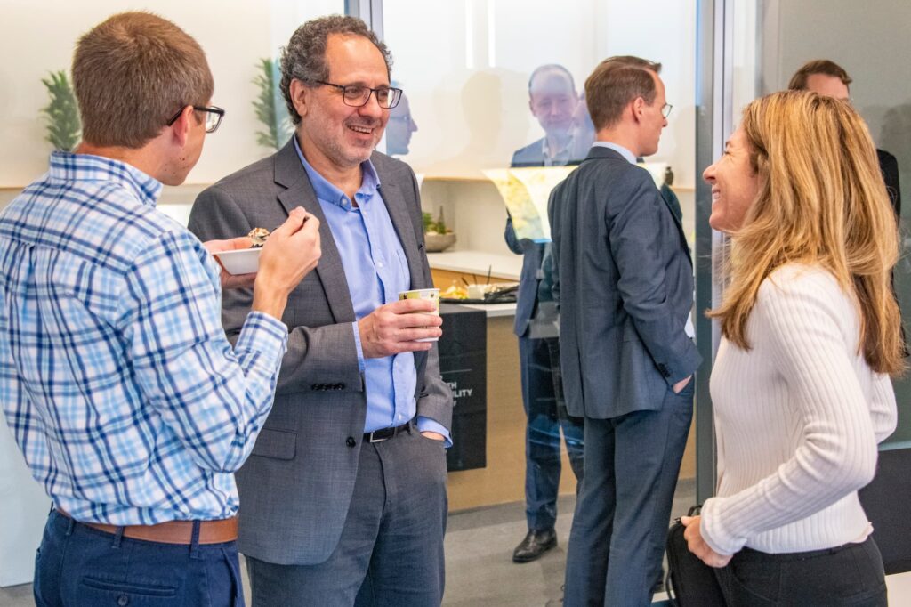 Attendees continue the conversation over coffee after the conference.