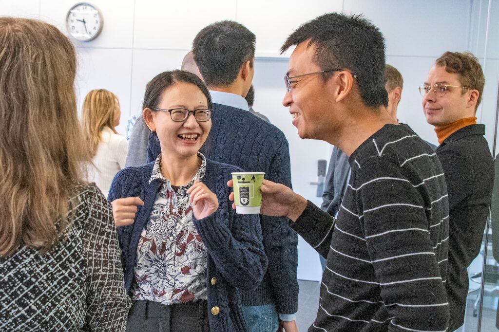 Attendees continue the conversation over coffee after the conference.