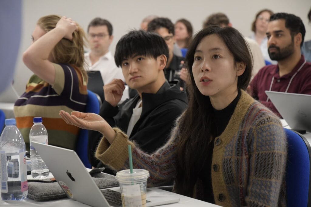 An attendee poses a question to the lecturer.