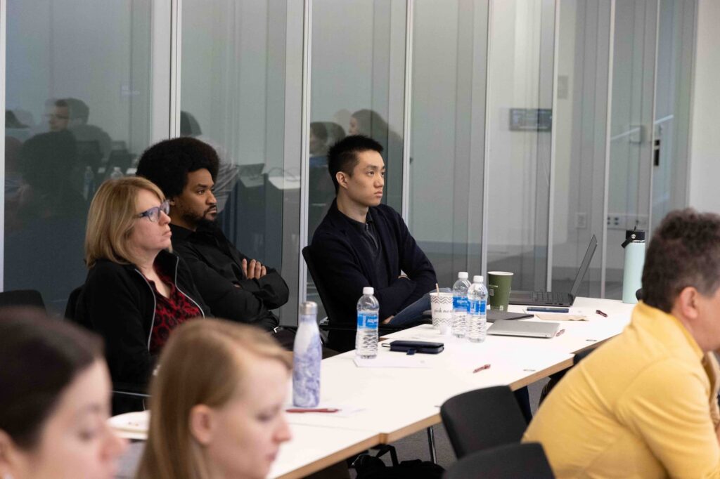 Audience members listen attentively during the lecture.