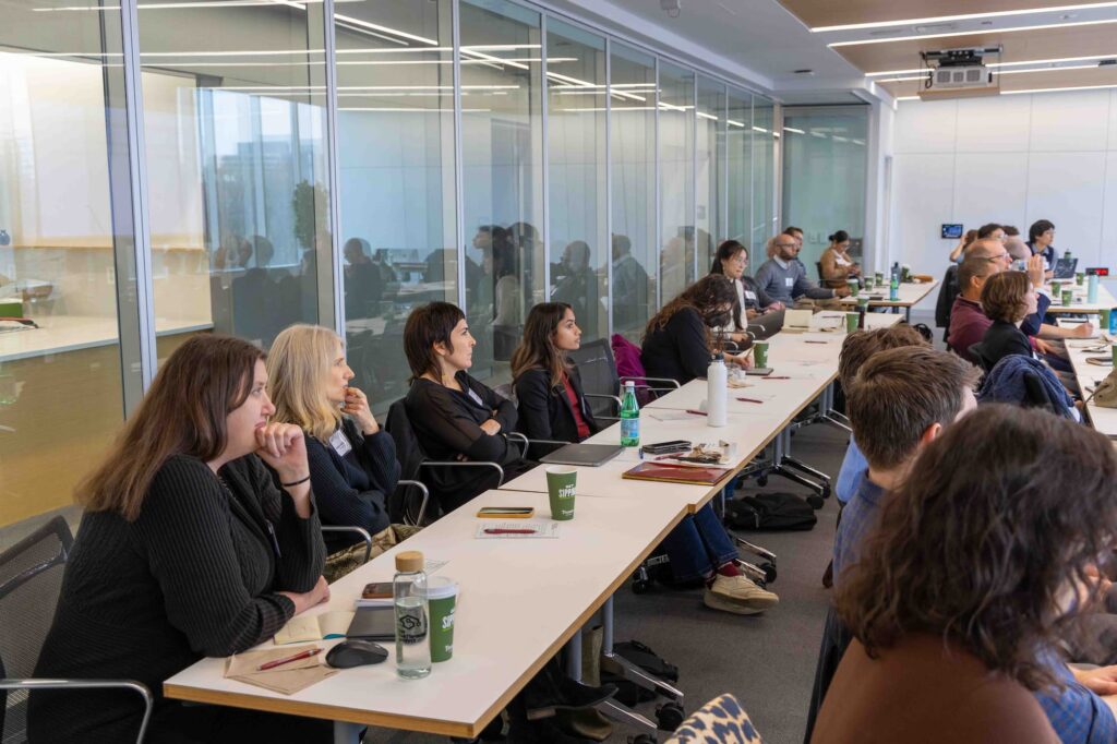 Audience members listen attentively during the lecture.