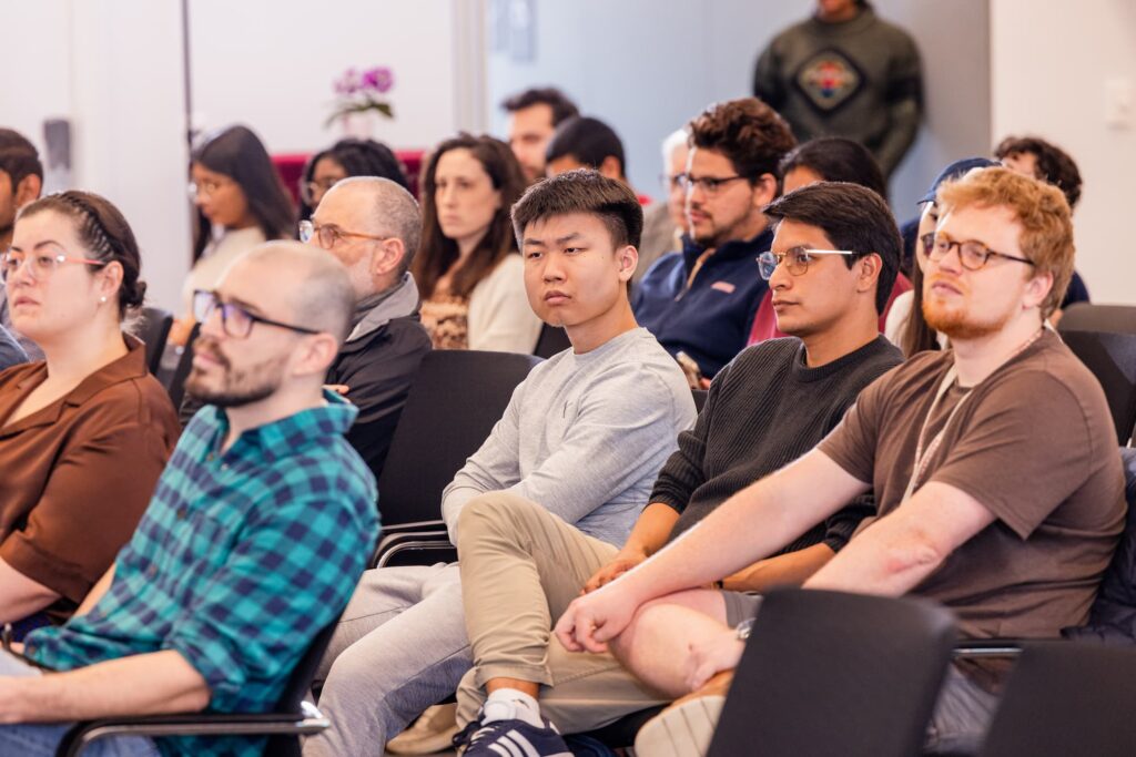 Audience members listen attentively during the discussion.
