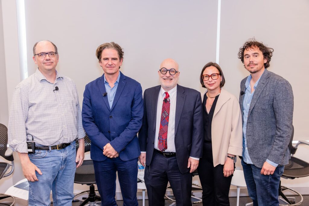 Panelists gather for a group photo following the discussion.