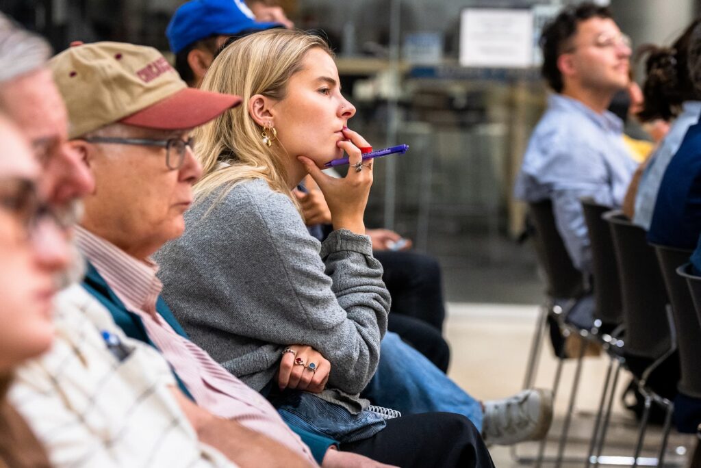 Audience members listen attentively during the discussion.