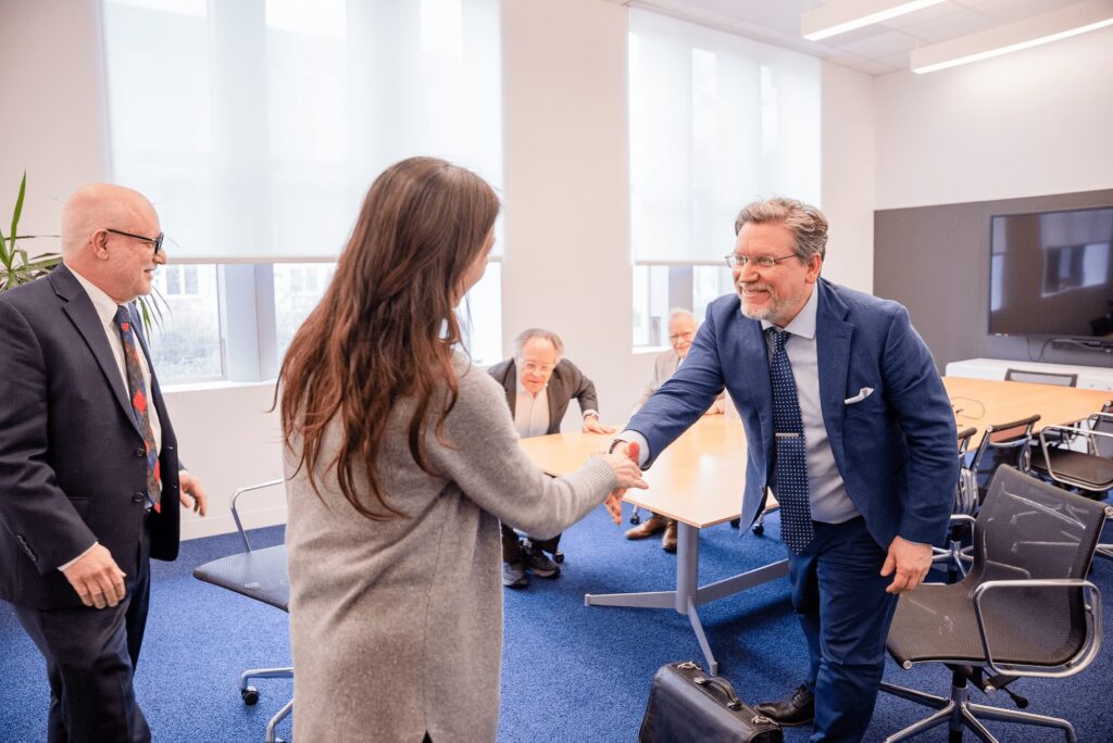 Panelists greet one another with a handshake before the session begins.