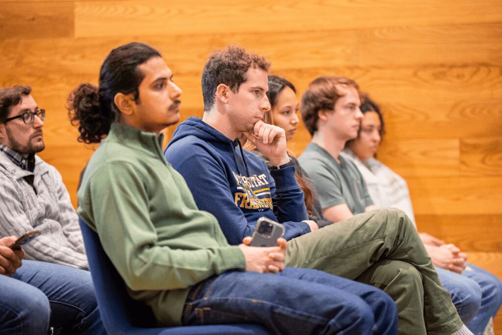 Audience members listen attentively during the discussion.