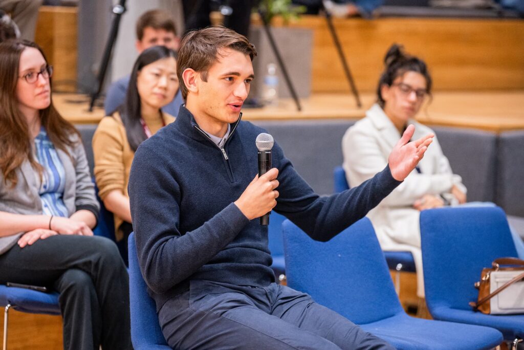A participant raises a question during the Q&A session.