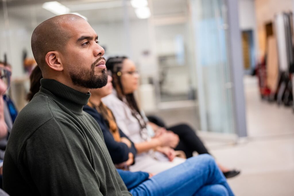 Audience members listen attentively during the discussion.