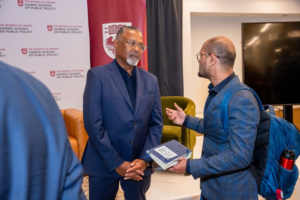 A panelist and an audience member engage in conversation following the session.