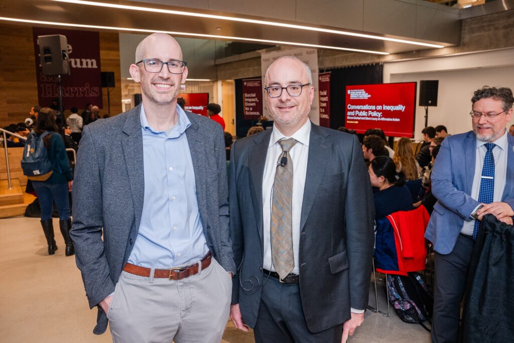 A panelist and Stone Center member pose for a photo following the discussion.