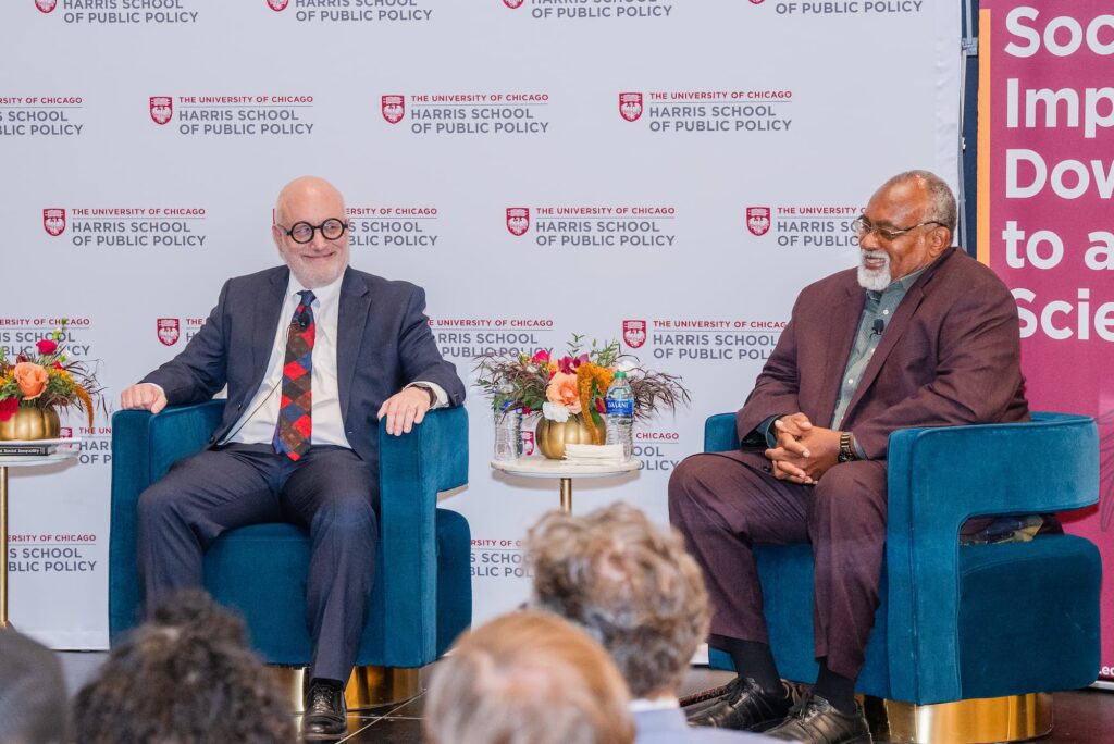 Two panelists share a light moment during the session.