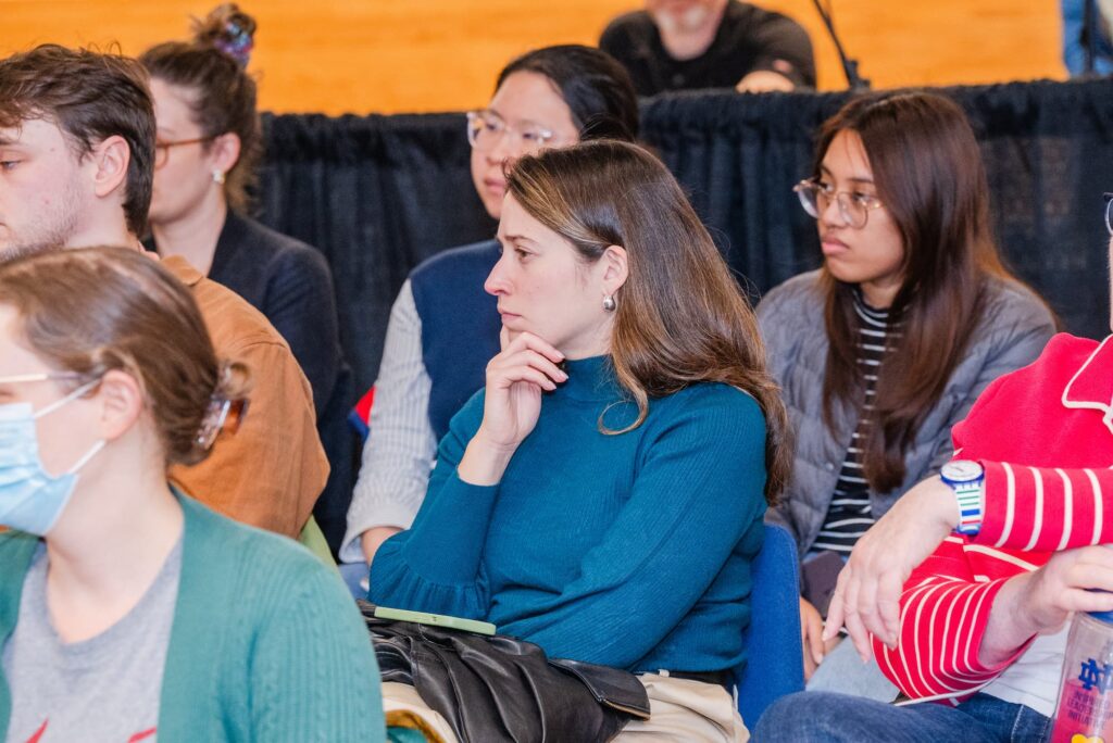 Audience members listen attentively during the discussion.