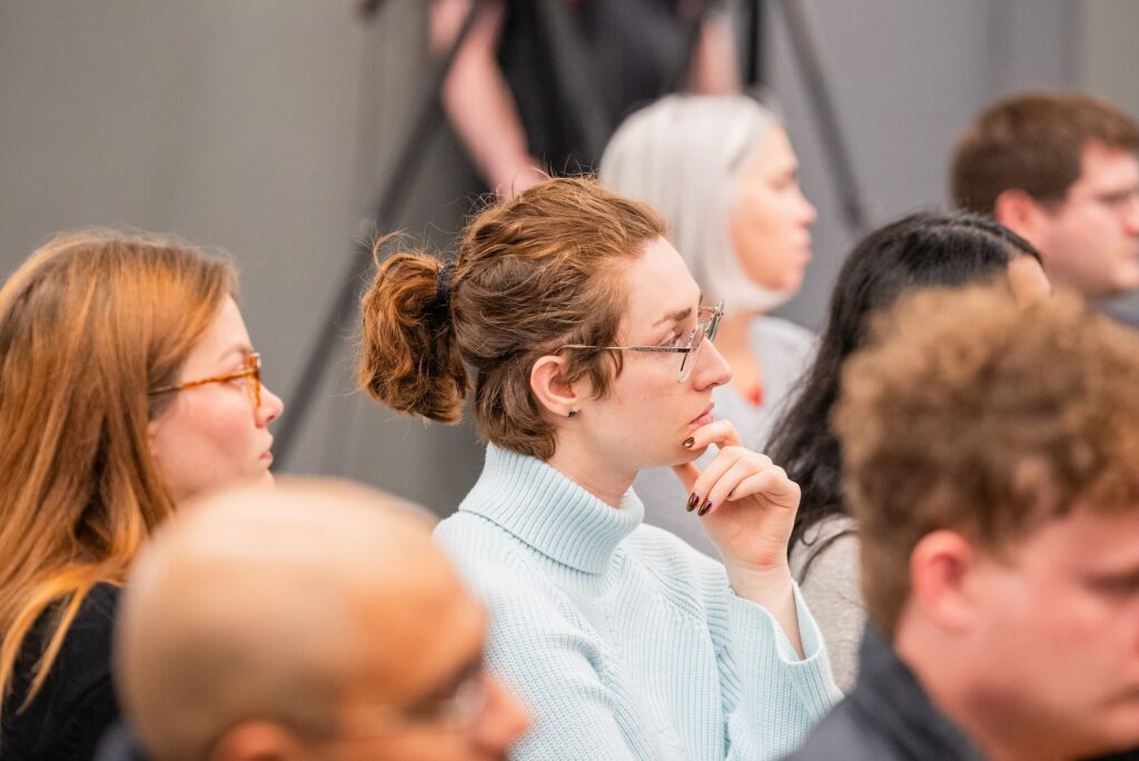 Audience members listen attentively during the discussion.