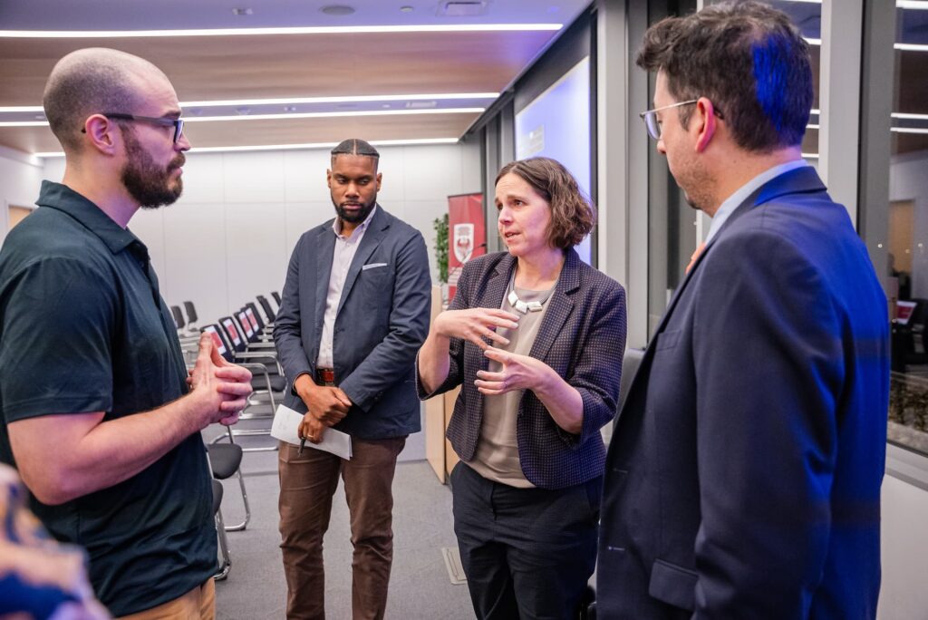 A panelist and Stone Center member engage in conversation following the session.
