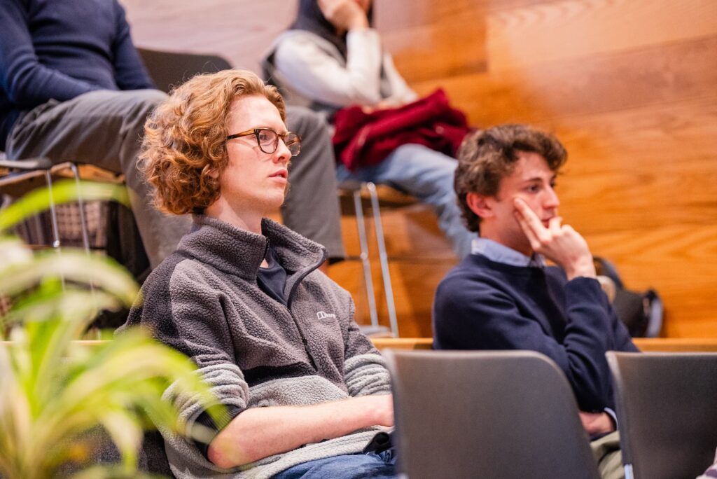 Audience members listen attentively during the discussion.