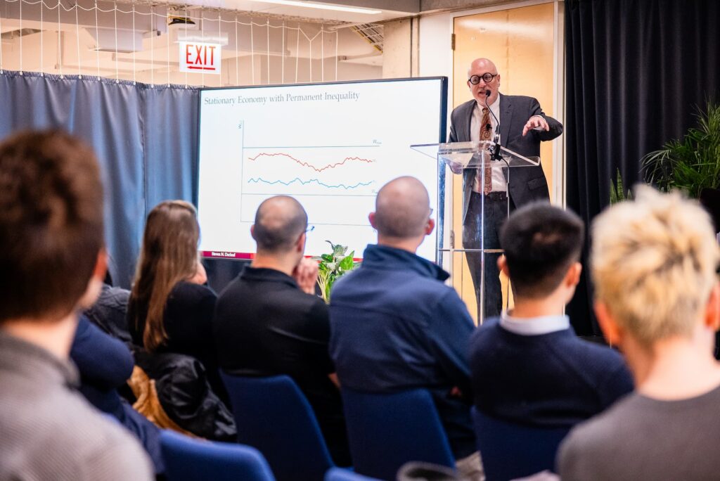 A panelist presents a graph to illustrate a key point