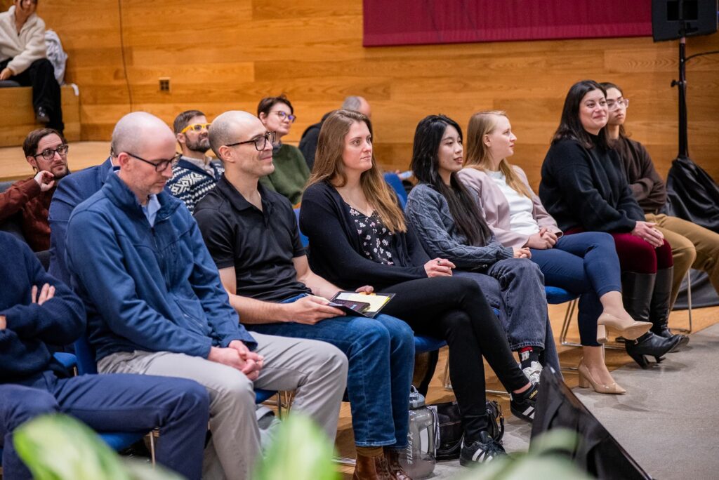 Audience members listen attentively during the discussion.