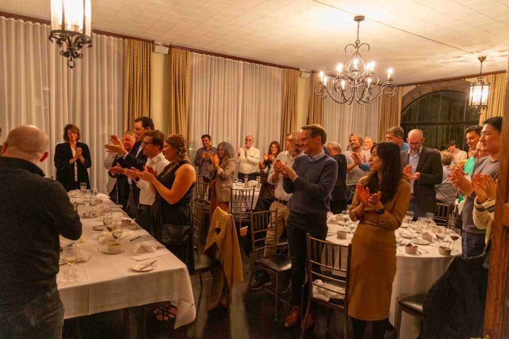 Attendees applaud following the speaker’s dinner remarks.