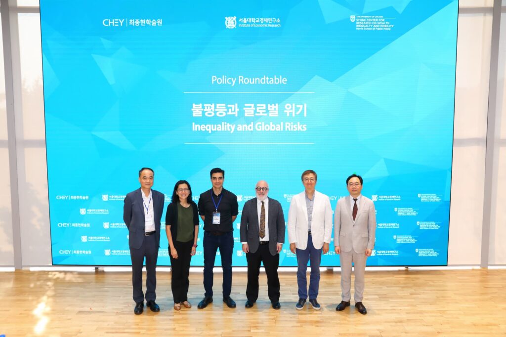Speakers gather for a group photo following the discussion.