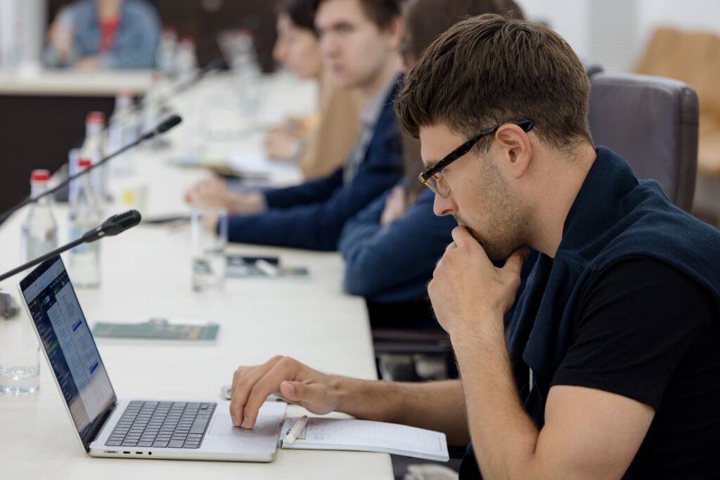 An attendee takes notes of the presentation.