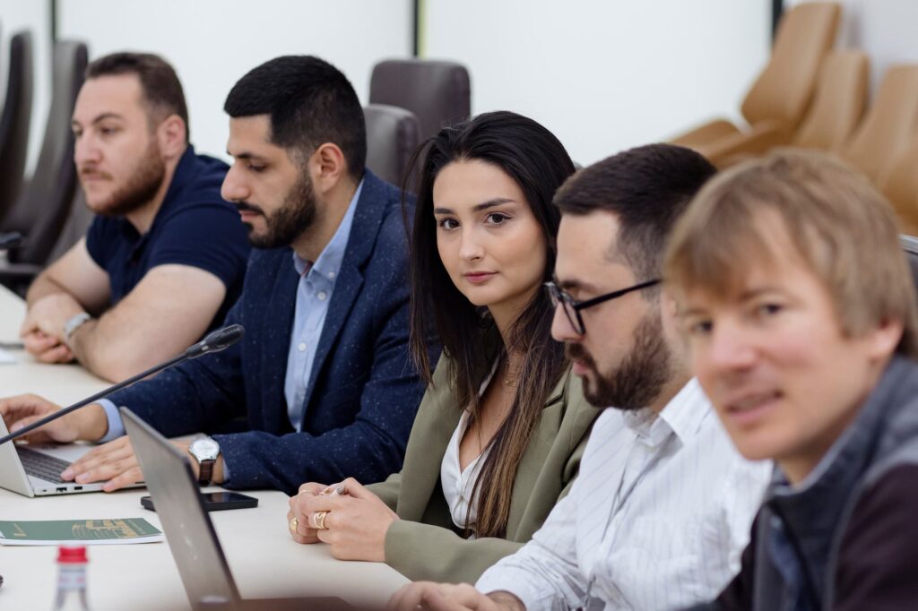 Attendees attentively listen to the presentation.