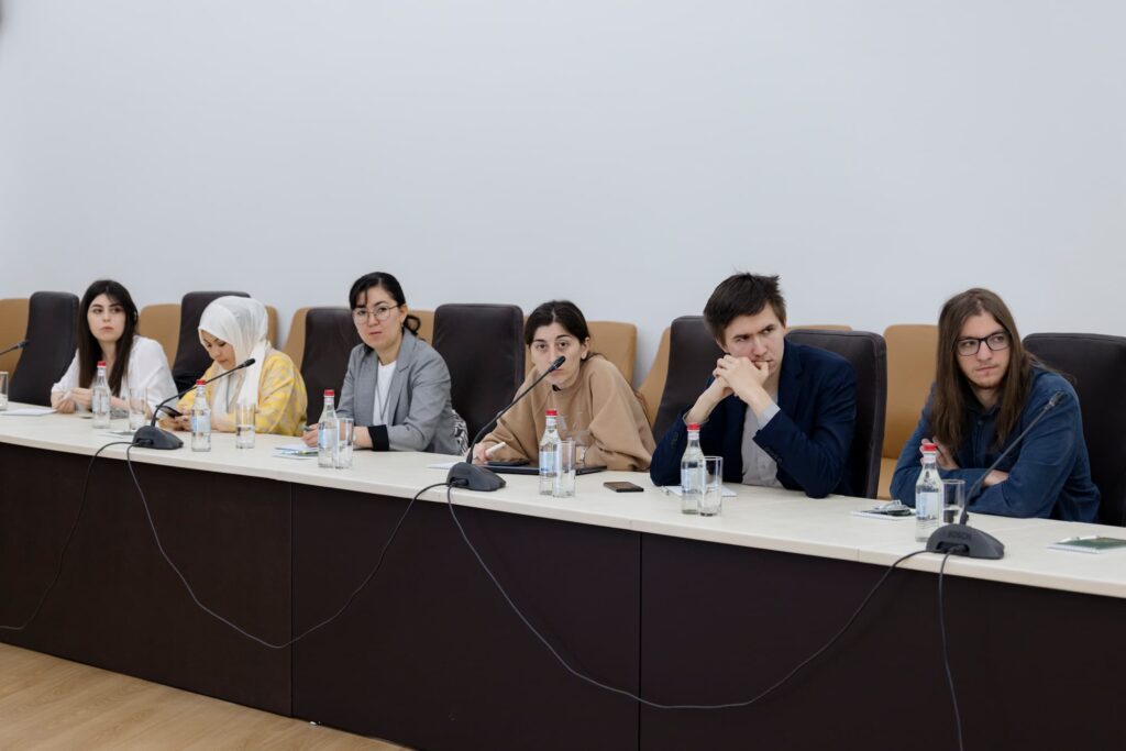 Attendees attentively listen to the presentation.
