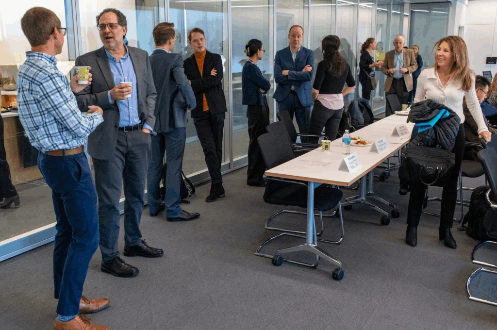 Attendees continue the conversation over coffee after the conference.