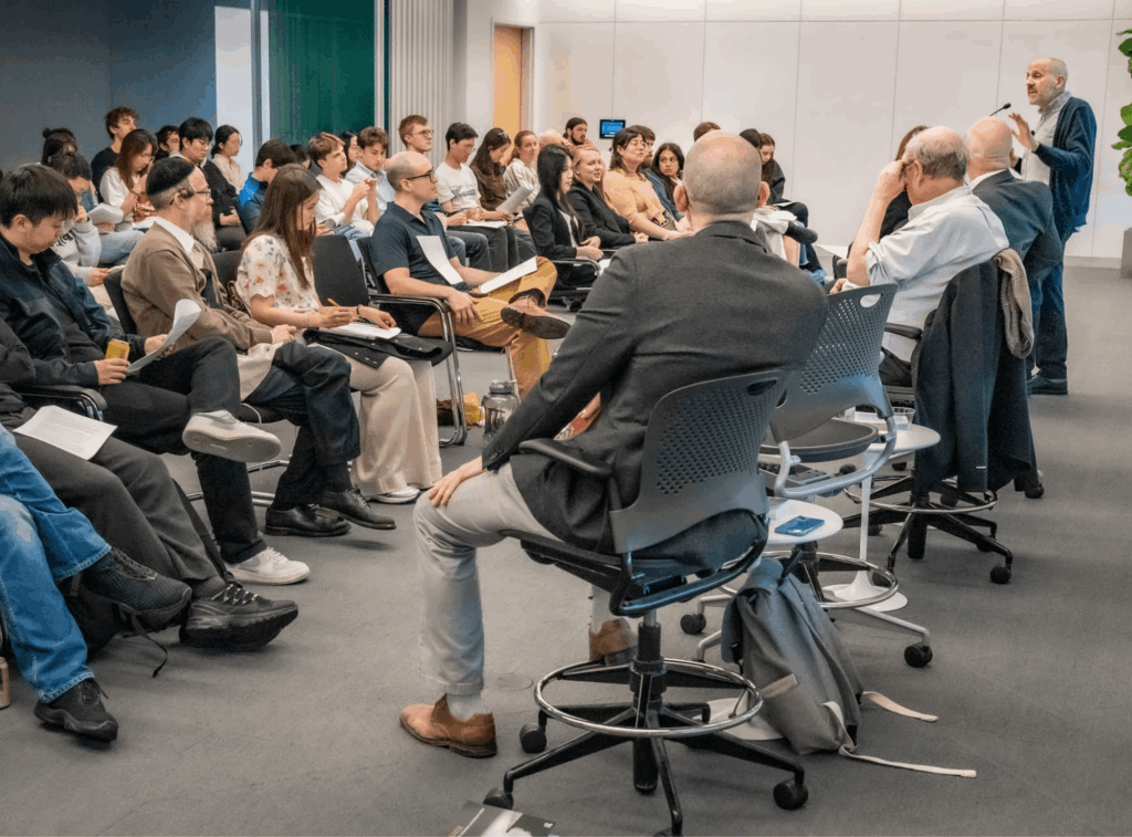 Audience members listen attentively during the discussion.