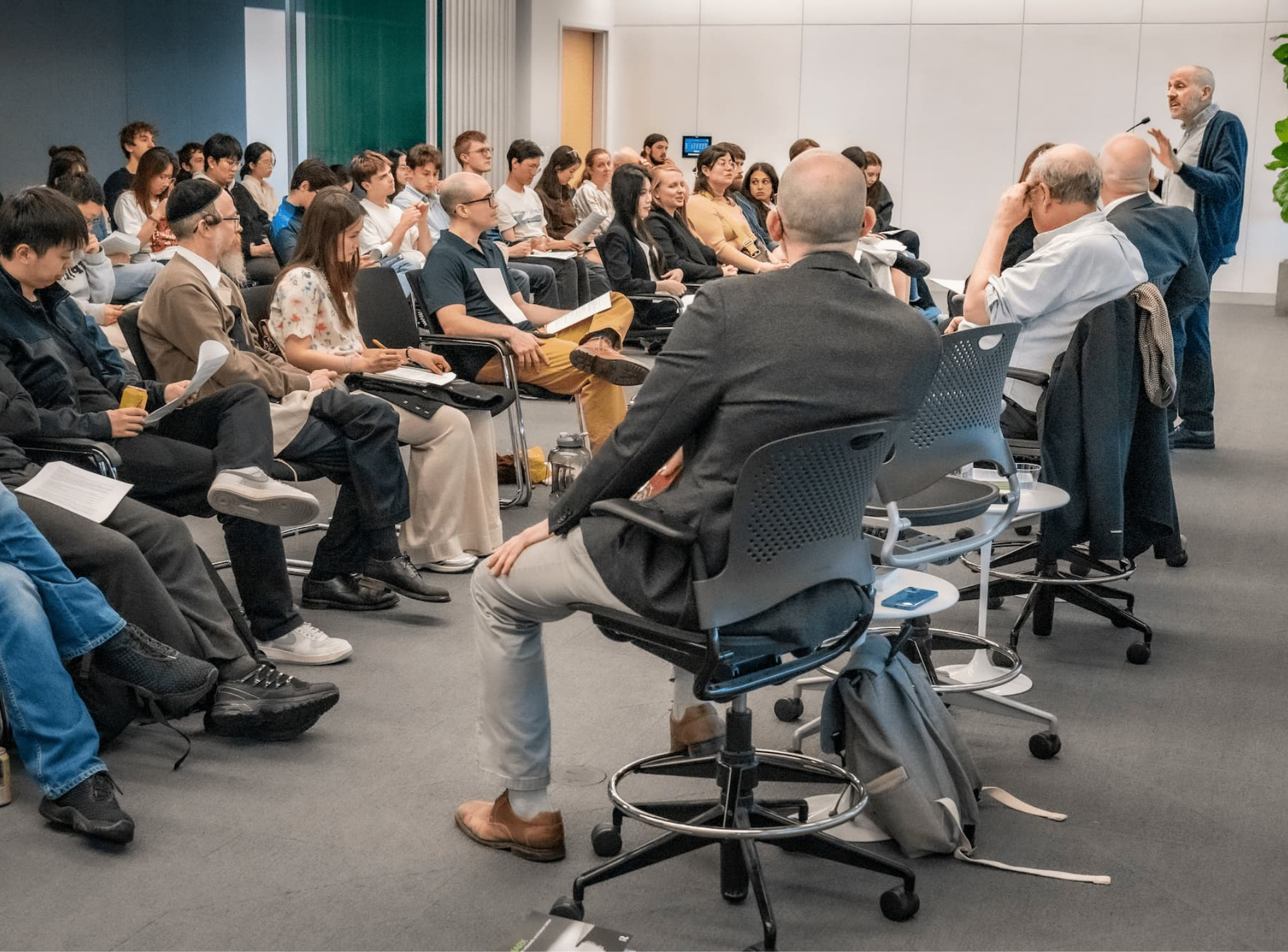 Audience members listen attentively during the discussion.